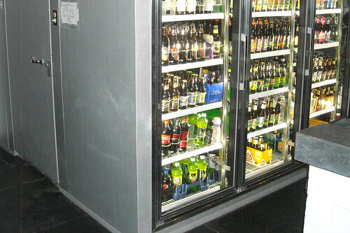 Male manufacturer carrying keg in brewery