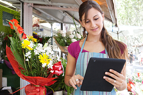 Woman standing outside florist